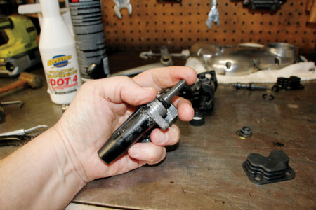 A hand holding the brake fluid lubricated cylinder
